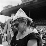 PROTECT YOUR DOME FROM THE SUN WITH NEWSPAPER: "1955. An American race-goer improvises protection from the considerable heat at Belmont Park race course." Just don't light your paper hat on fire with your cigarette. (Getty Images)